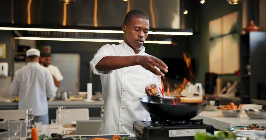 A private chef welcoming guests to a prepared dining experience